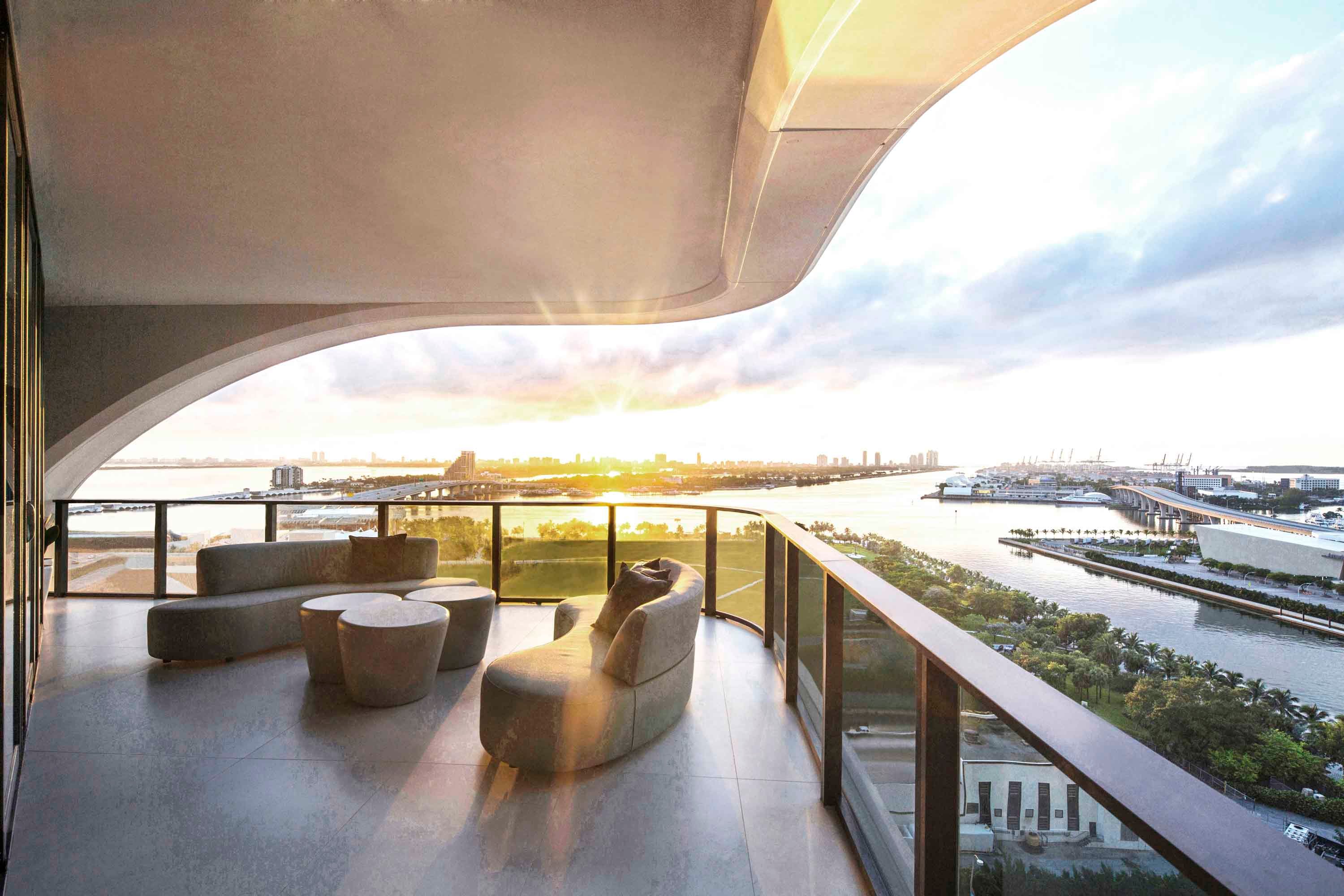 Luxury outdoor balcony with custom large-format floor tiles and curved architectural overhang at One Thousand Museum. Photo by Robin Hill.