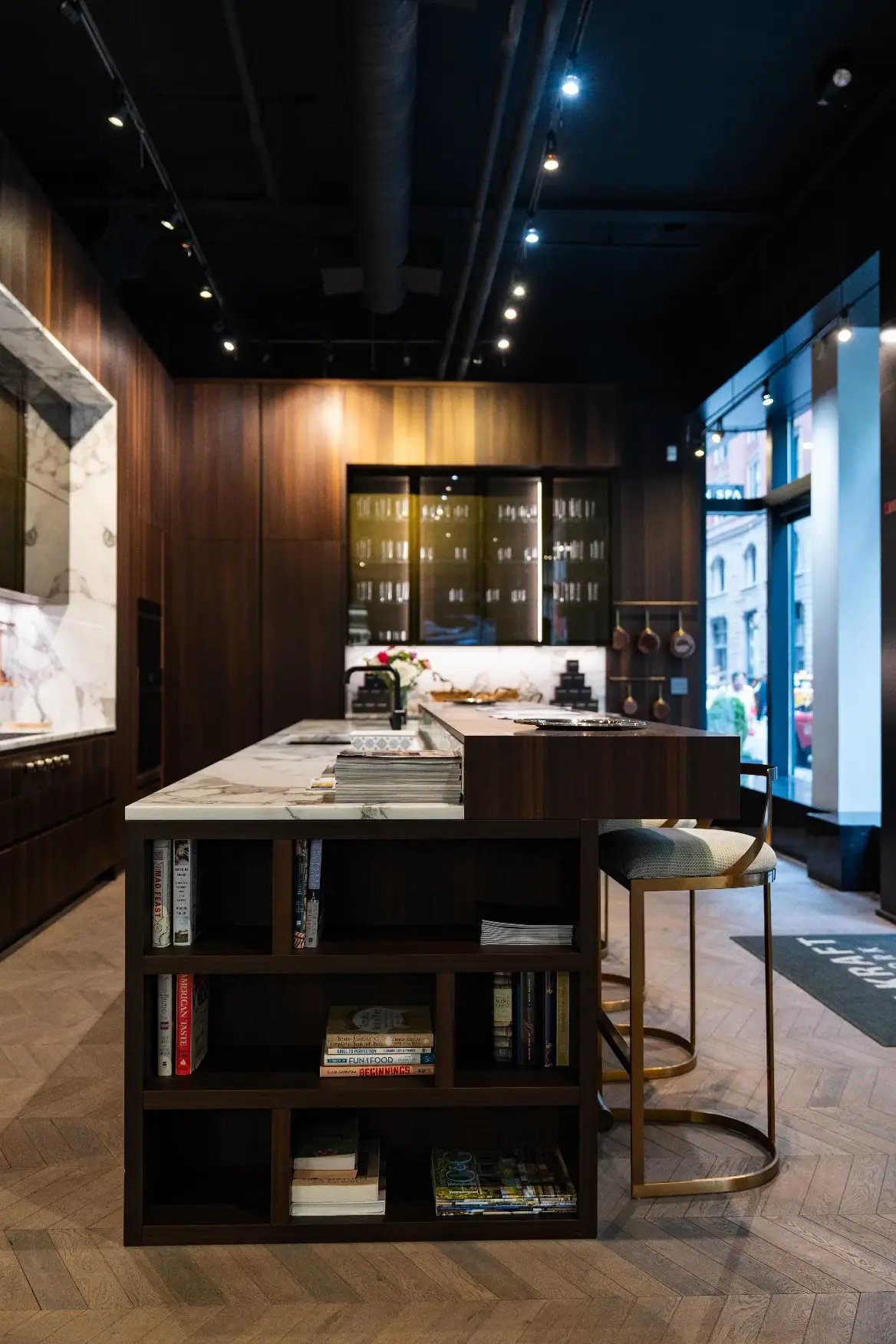 Closeup of kitchen island with integrated bookcase at ITALKRAFT's New York showroom